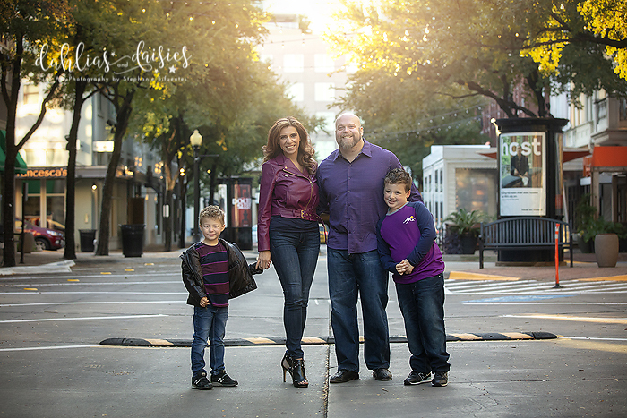 Family poses in the street wearing purple in the West Village