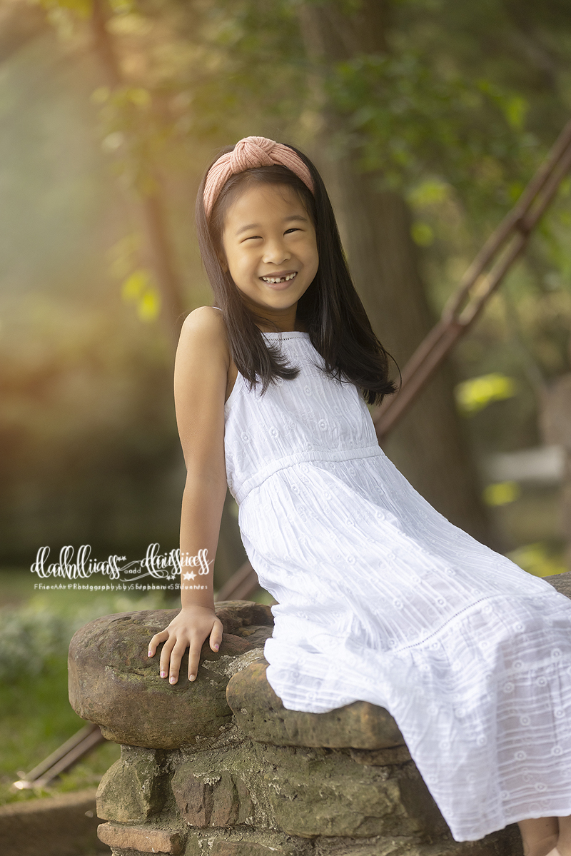 Beautiful little girl smiles during family photography session