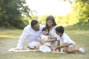 Family look at 12 month old baby at family portrait session