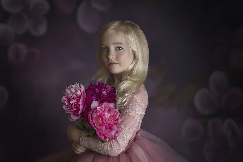 Beautiful 5 year old holds pink flowers at her Fine Art Photography session St Andrews