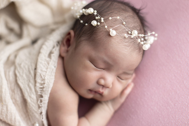 Close up of newborn girl at her newborn session

