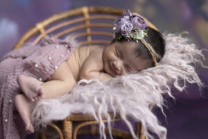 Sleeping newborn girl smiles
