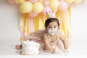 12 month old girl covered in cake at her 1st birthday cake smash