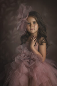 Beautiful 5 year old poses in pink and orange couture gown
