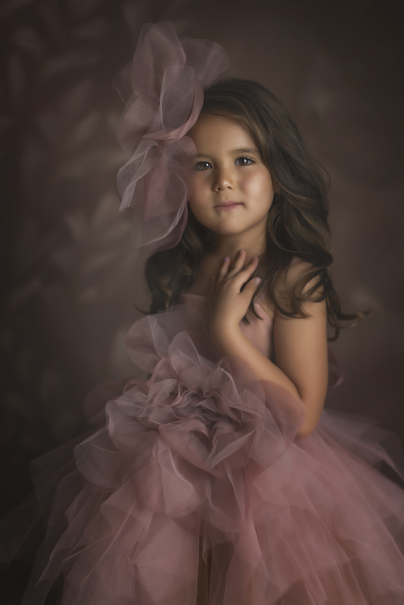 Beautiful 5 year old poses in pink and orange couture gown