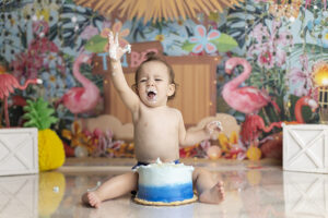 12 month old playing in cake at his cake smash
