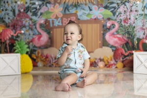 Cute baby boy smiles big at his first birthday photos hoot with a. Tiki bar theme