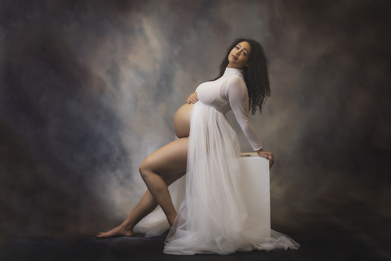 Beautiful pregnant woman wearing white dress