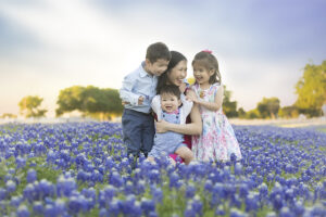 Mother with children in Dallas bluebonnet field