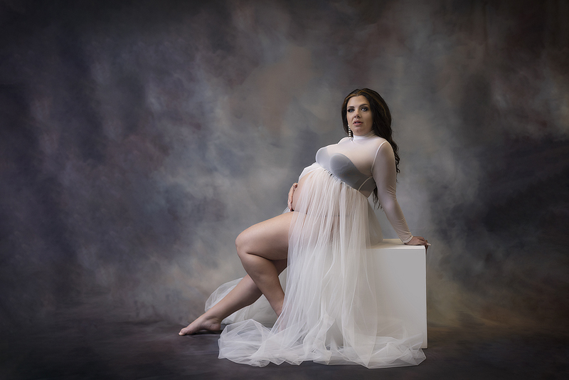Woman poses at her dallas maternity session