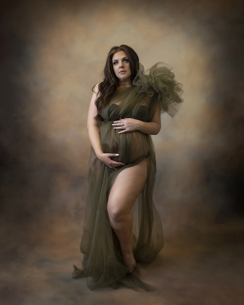 Woman poses in dress at Dallas maternity session