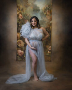 Pregnant woman poses in blue dress