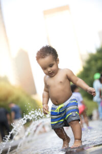 Boy splashes on splash pad