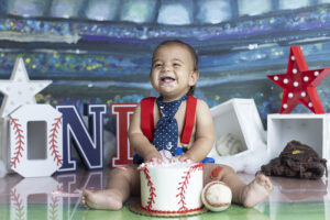 Baby laughs while playing with cake