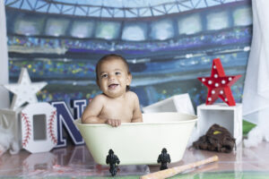 Baby boy laughs while splashing in mini tub