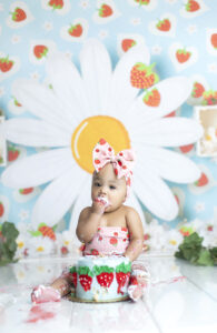 Baby eats strawberry themed cake