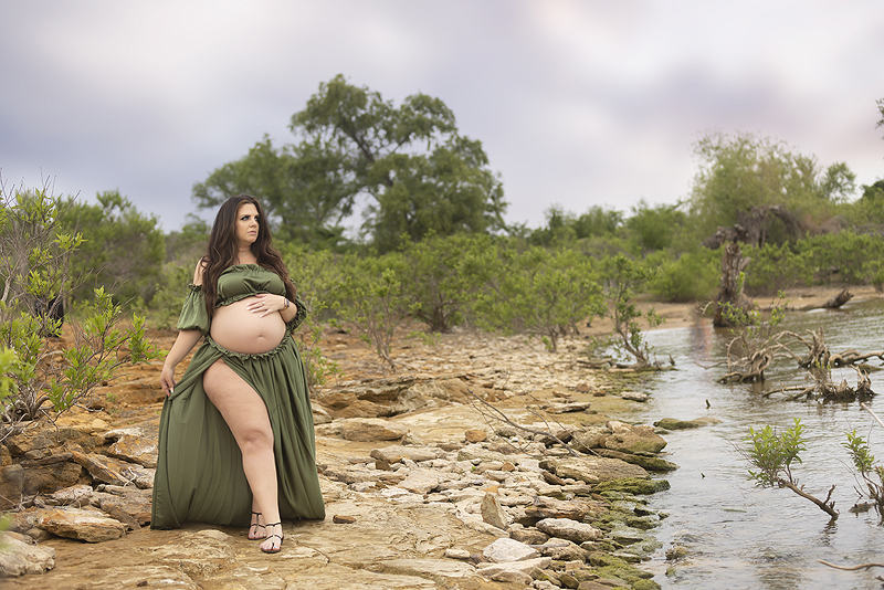 Pregnant woman walks along lake