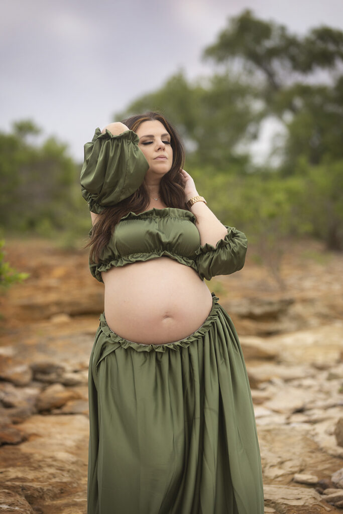 Woman poses at maternity session