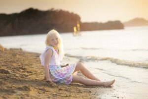 Girls sits on beach at Littel Elm Beach