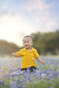 Boy plays in bluebonnet field