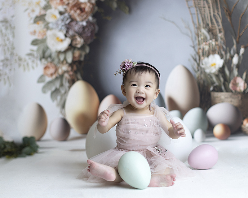 Baby laughs at studio spring photo session