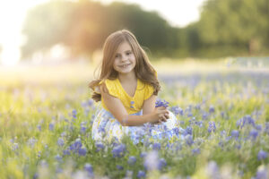 Spring photography session with a girl in bluebonnet field