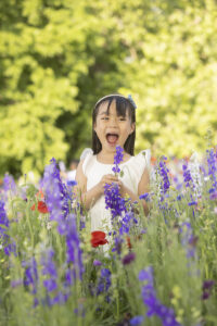 Girl laughs in flower field