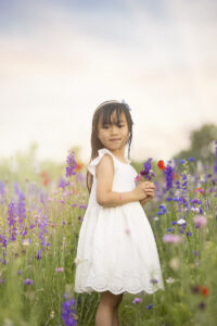 Girl picks flowers in wildflower field