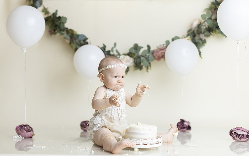 Baby reacts to cake at cake smash session
