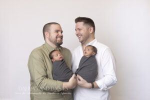 Proud fathers with twin newborn boys