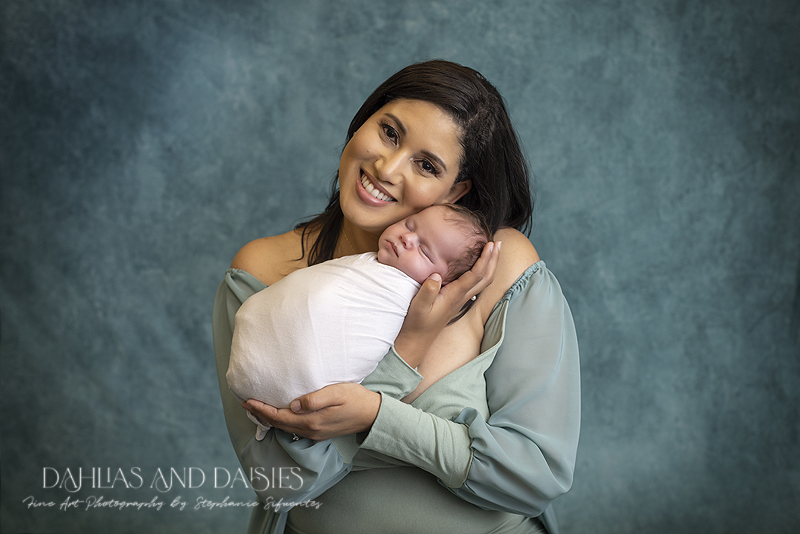 Mother holds newborn at Plano newborn photographer photoshoot