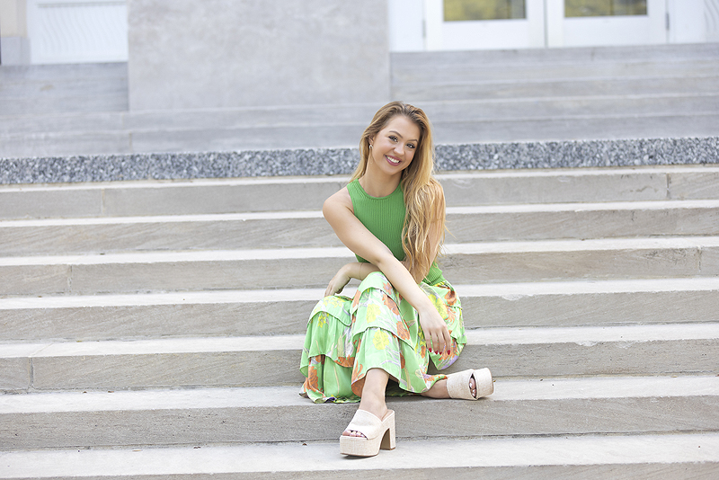 Young woman sits on stairs