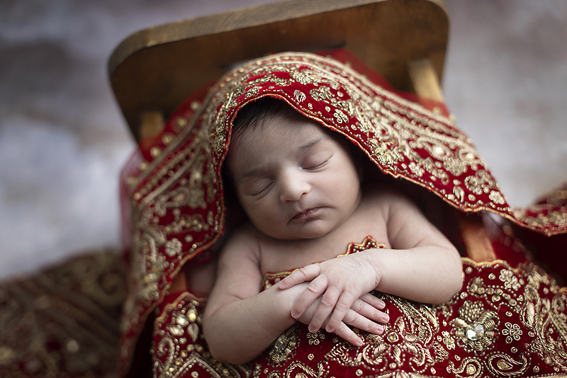 Newborn girl in mothers sari