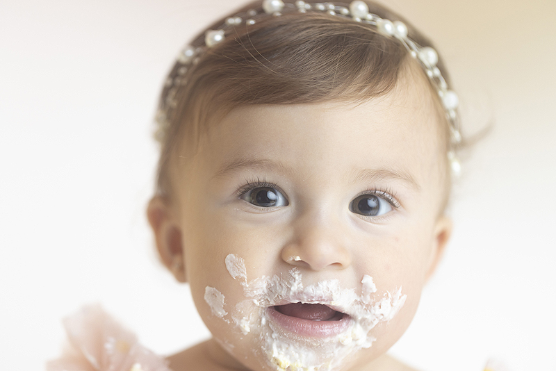 Close up of icing covered baby face