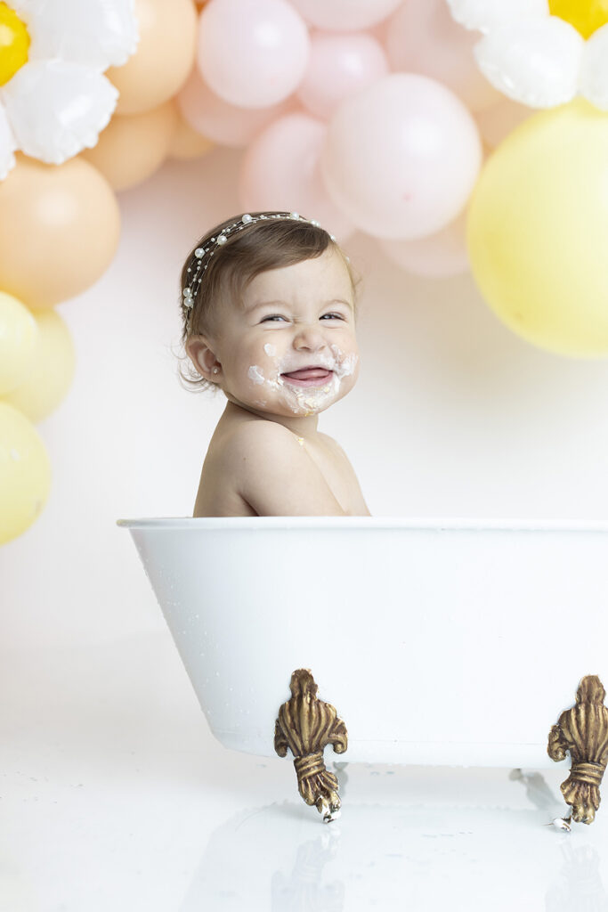 Baby smiles at daisy cake smash