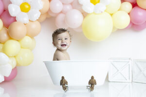 11 month old splashes in tub during cake smash