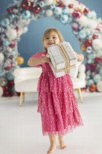Young girl dances with presents