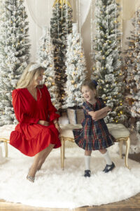Mother and daughter play during christmas photos