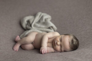 Newborn boy sleeps one side