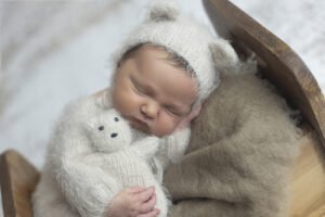 Dallas newborn photographer poses newborn in adorable bed