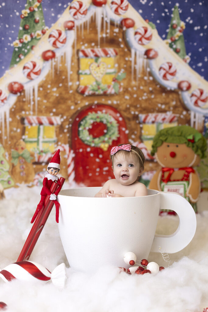 Baby plays in over sized hot coco cup