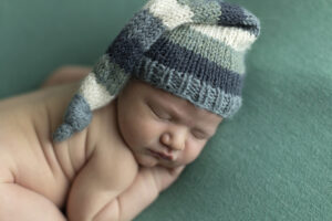 Newborn boy wearing knitted hat