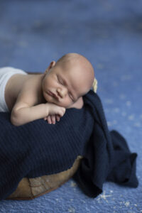Newborn boy rest head in basket