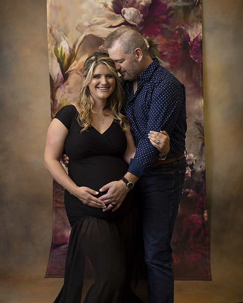 Couple hugs at maternity photo session