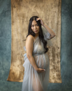 Pregnant woman poses in blue tulle