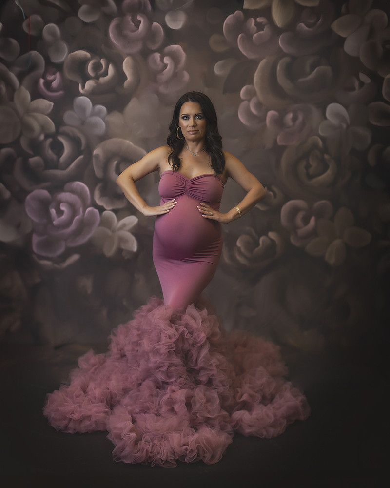 Woman wears pink maternity gown during her maternity photo session