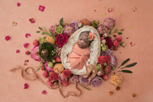 Newborn girls surrounded by flowers