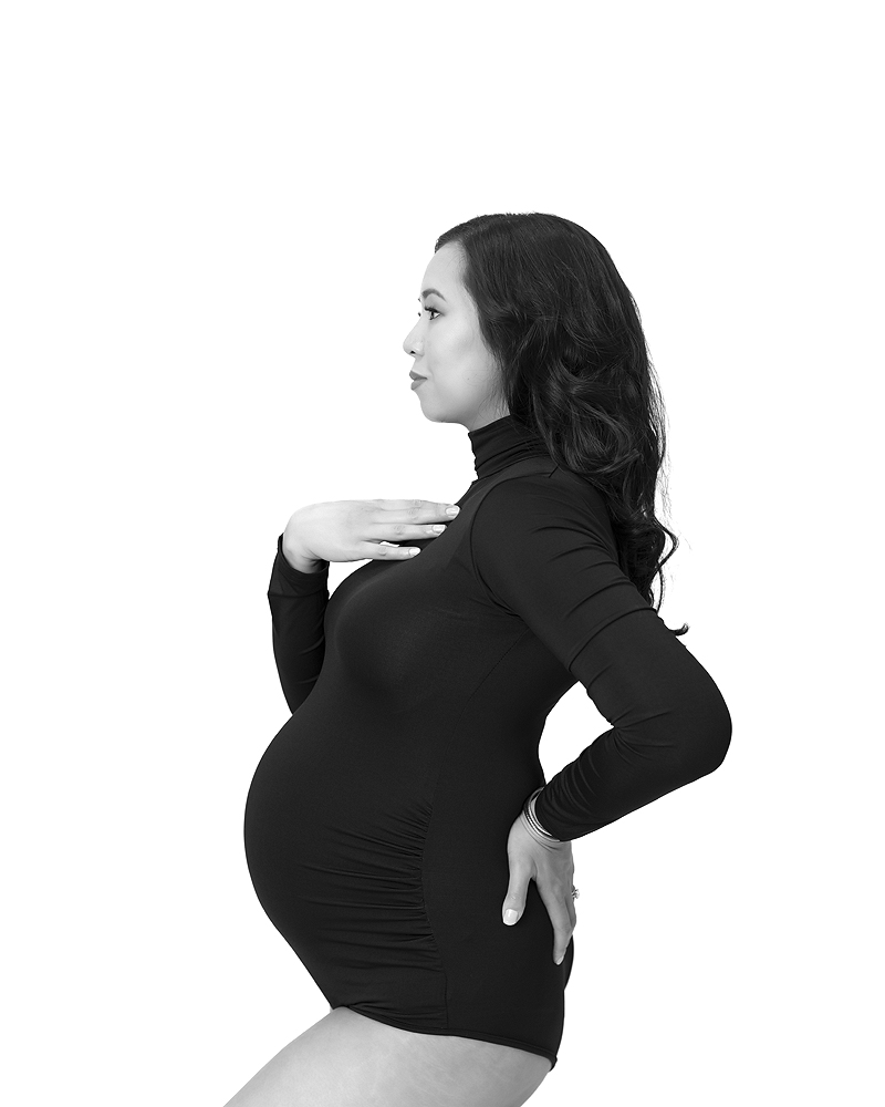 Pregnant woman poses in black body suit