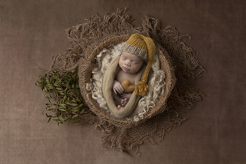 Newborn boy rests in basket