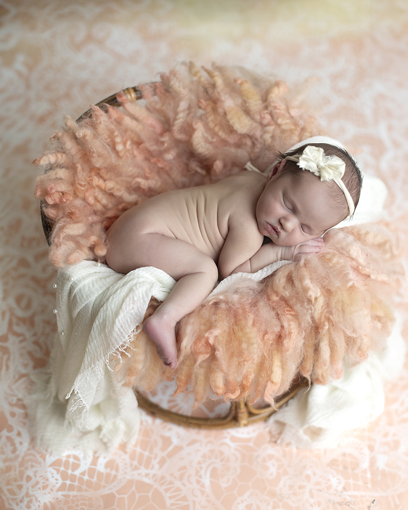 Newborn girl on peach